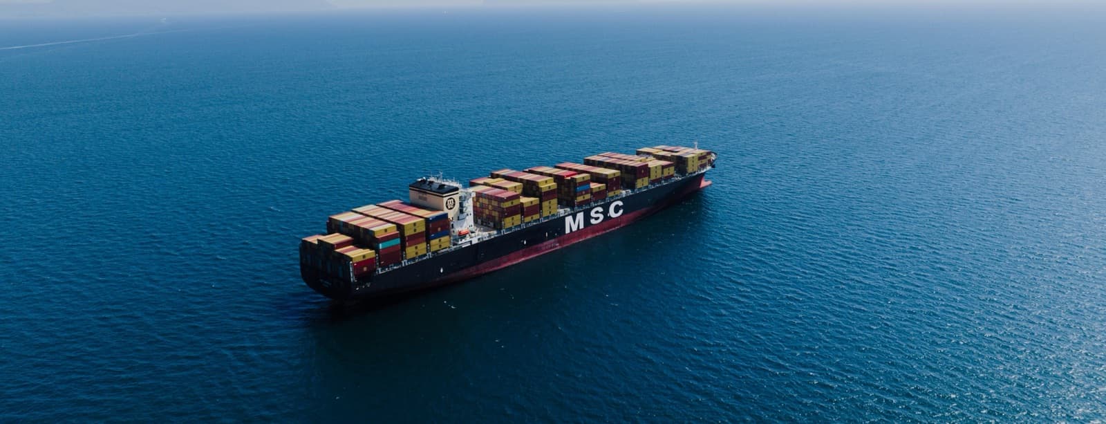 Cargo vessel at sea — the world he entered at eighteen